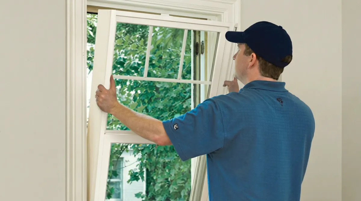 Professional contractors performing a residential window insulation and replacement service in Peoria, IL